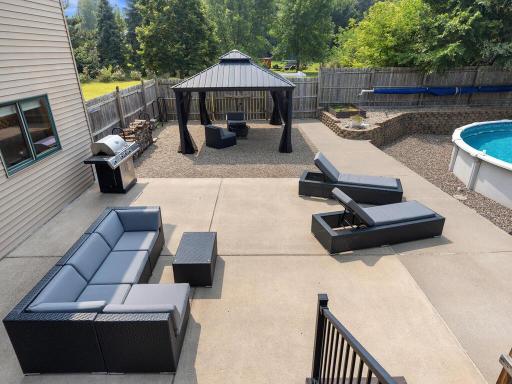 The updated kitchen shines with stainless steel appliances, granite countertops, and a ceramic tile backsplash, while vaulted ceilings create a bright, open feel