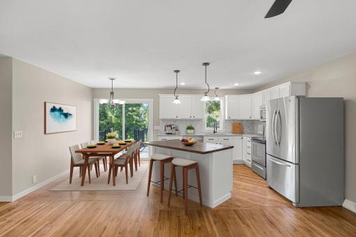 Kitchen and dining room would be a great place to gather family and friends. Hardwood floors and a deck out back. This photo is digitally enhanced.