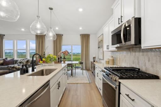 (Photo of model home, finishes will vary) The kitchen overlooks the dining room for an easy transition between cooking and mealtime