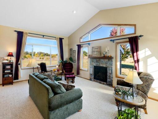 Sun-filled Great Room with stone-faced gas burning Fireplace