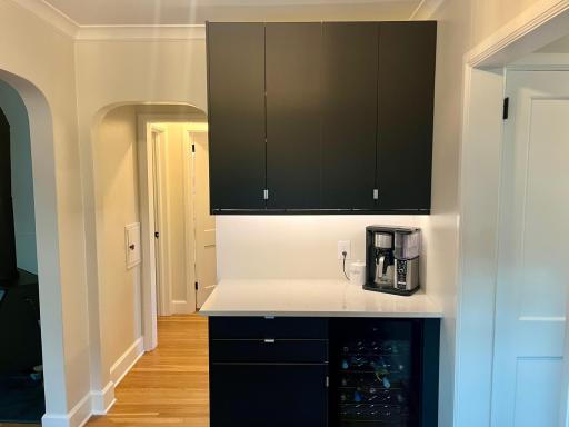 Bar/coffee bar and serving area with updated cabinetry, quartz countertops and a built-in beverage fridge.