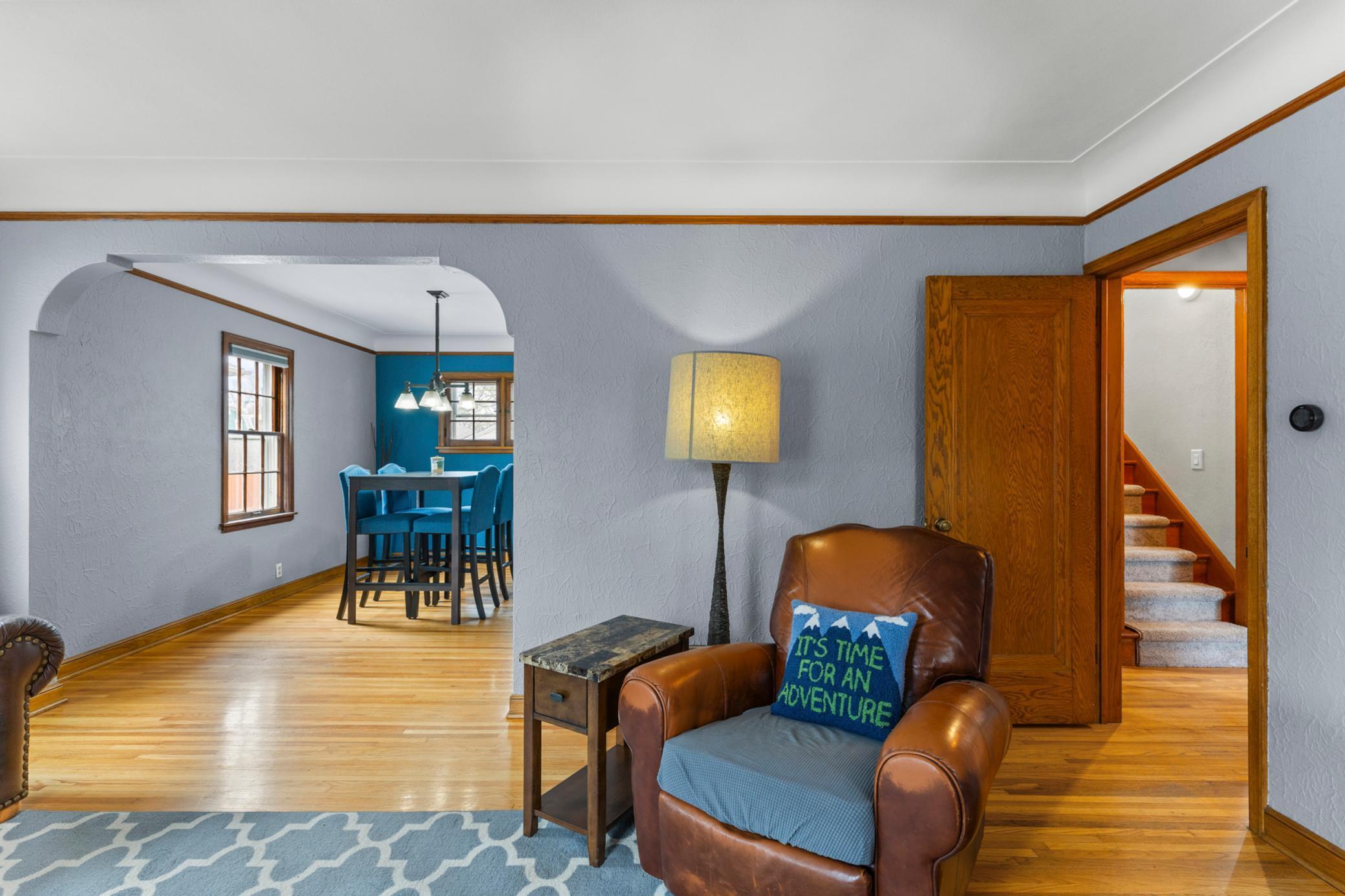 Living room with dining to the left and doorway to bedrooms to the right.