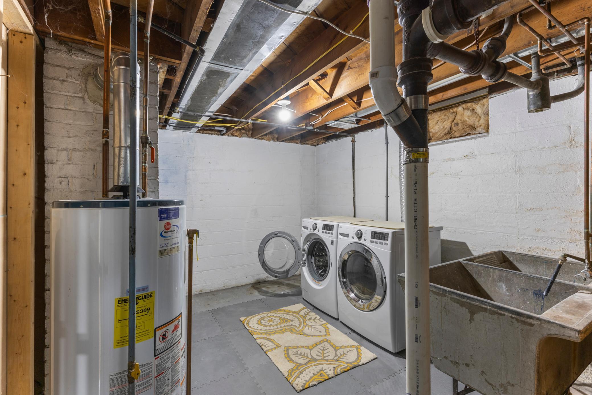 Spacious laundry room with additional storage spaces.