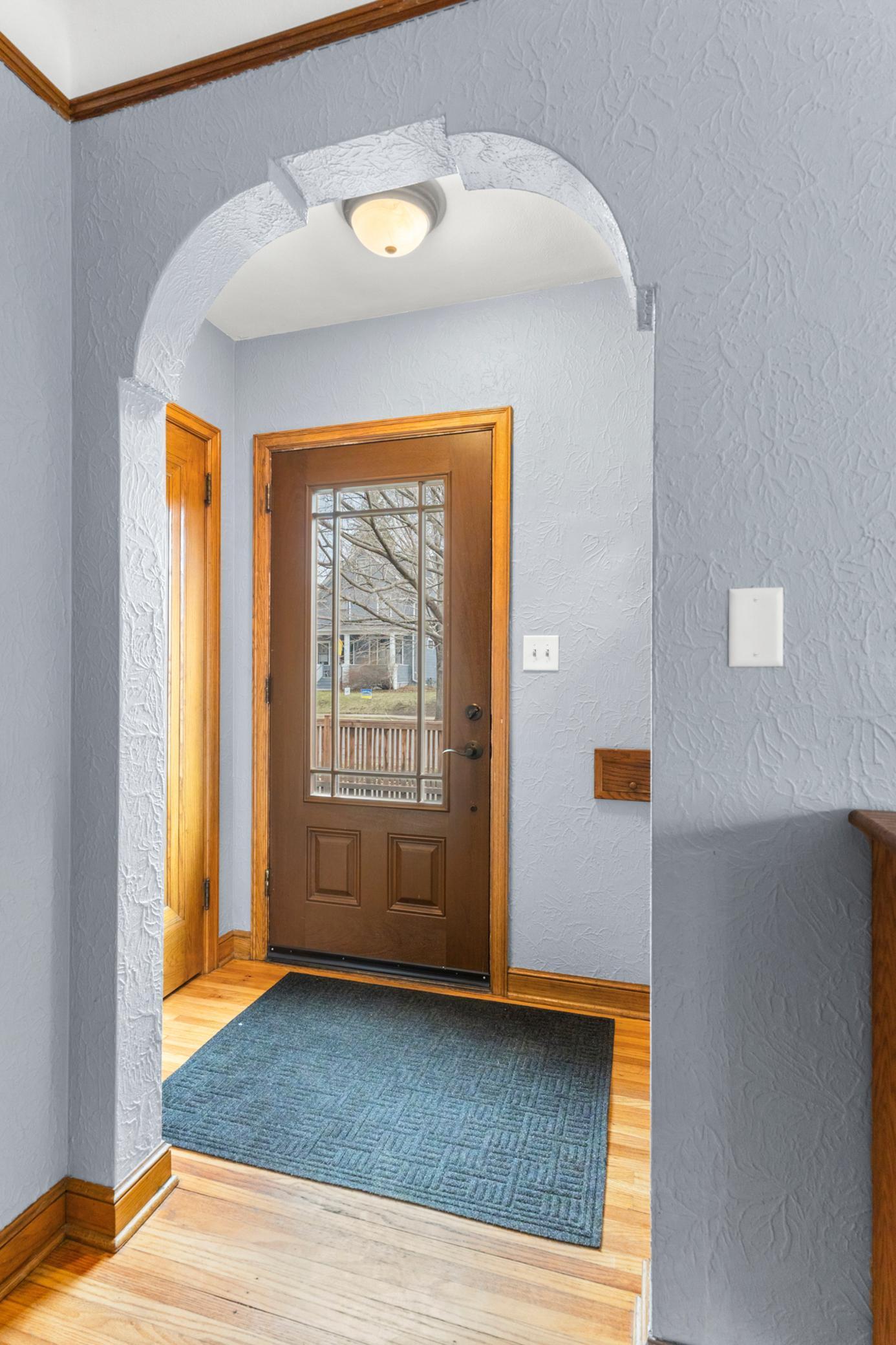 Front entry with coat closet & beautiful archway.
