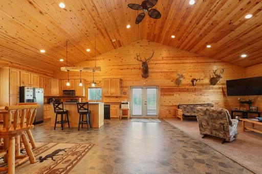 Oversized open concept living area with double doors out to back patio