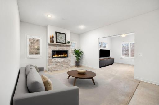 Modern warmth meets minimalist design—this virtually staged living room features a sleek fireplace as its striking centerpiece, creating a space that’s both inviting and refined.