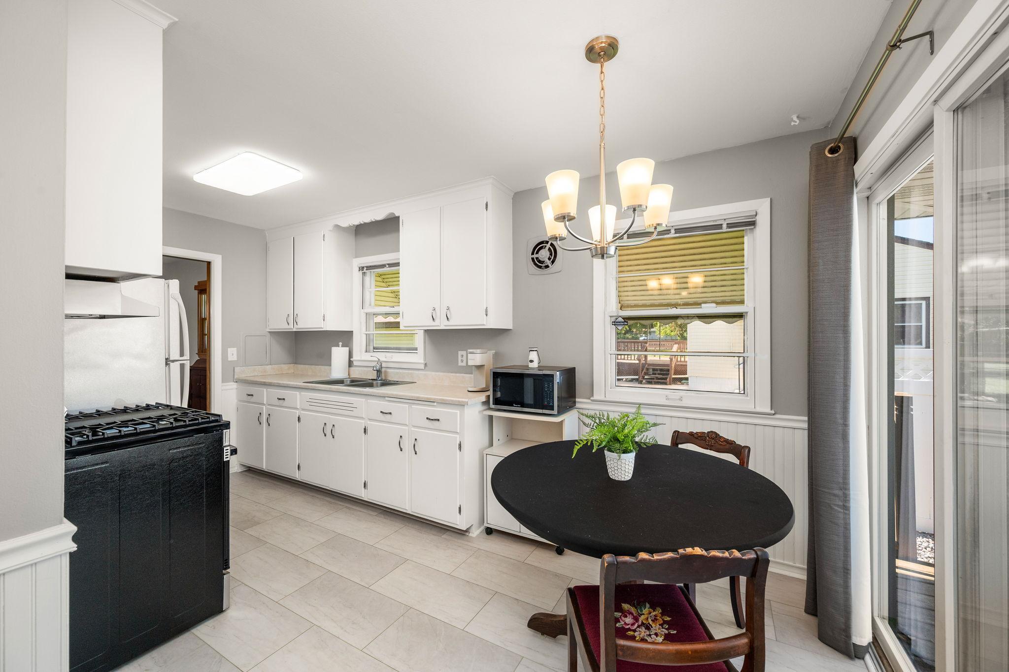 From your eat-in kitchen, Step out the newer sliding glass door to your deck and private side yard!