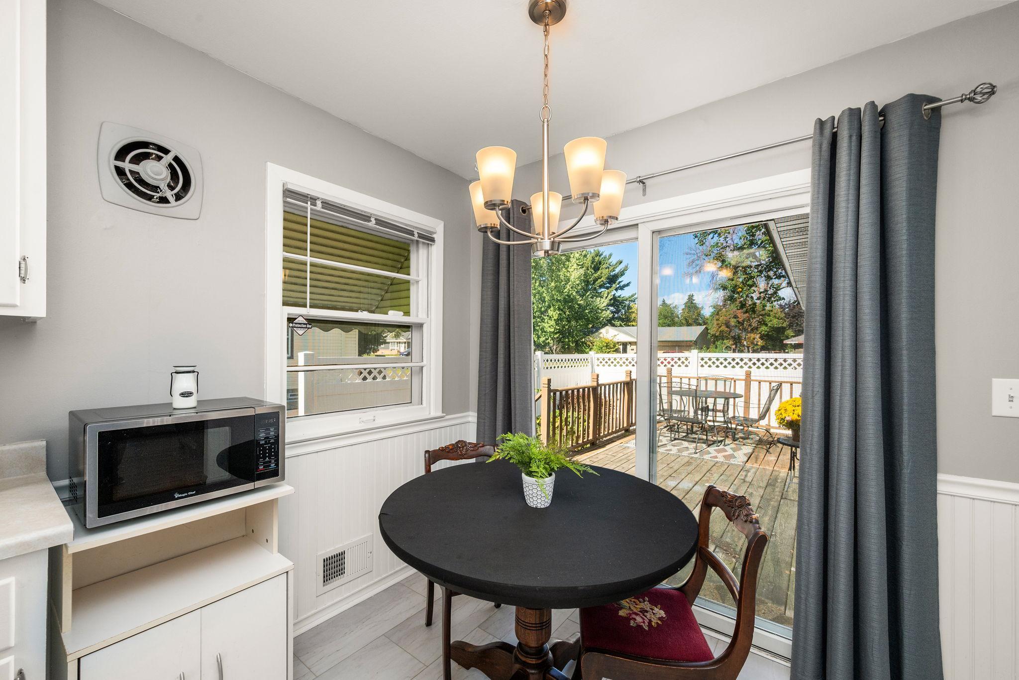 From your eat-in kitchen, Step out the newer sliding glass door to your deck and private side yard!