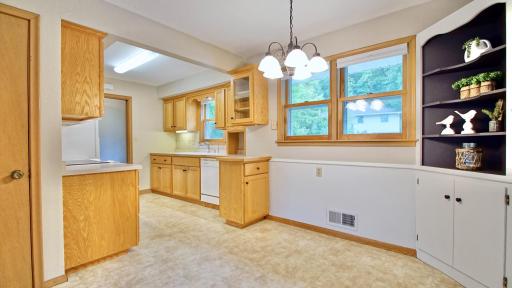 Dining area with kitchen to the left. Doorway in far left of picture leads to the lower level.