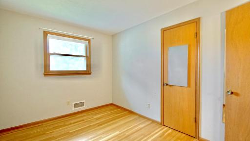 First bedroom on the left as you come down the main level hallway. Oak hardwood floors.