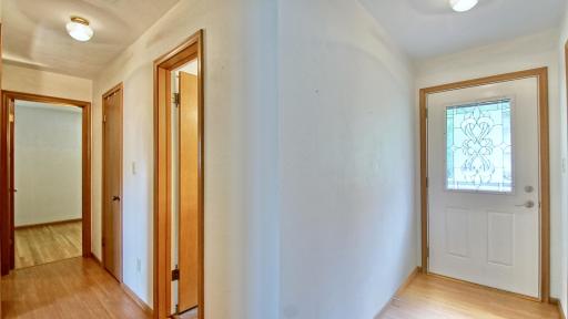 Front door is on the right. Hallway to full bathroom and three bedrooms on main level to the left.