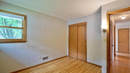 Interior view of bedroom. Main level hallway to the right.