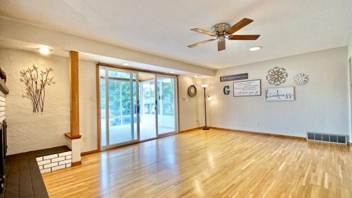 Living room with oak hardwood floors. Three season porch to the left.