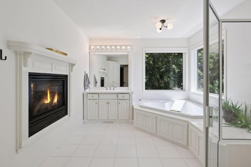 Primary bath with double sided fireplace to primary bedroom