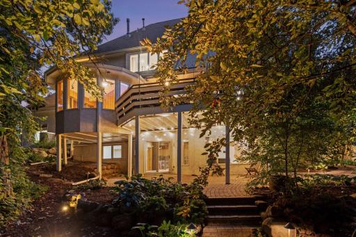 Charming backyard retreat with deck, patio, and ambient lighting