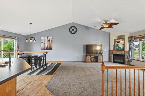 large upper level living room with vaulted ceilings and gas fireplace