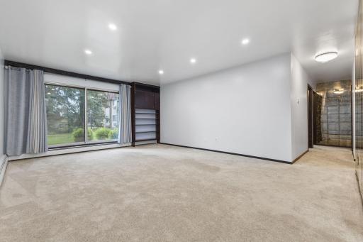 Recessed lighting and large windows create for an open and airy living space.