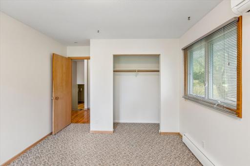 This bedroom may have hardwood under the carpet.