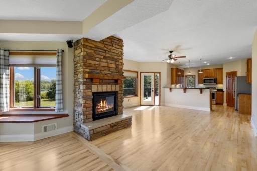 Cozy up by the stone fireplace with panoramic pond views.