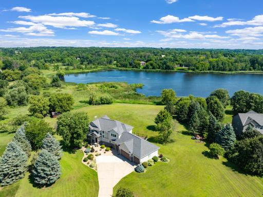 Beautiful Lakeville home with 4-car garage & waterfront backdrop