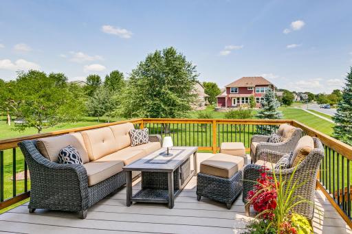 Entertainment size deck, featuring maintenance free flooring. Staircase conveniently placed for access to the rear yard space.