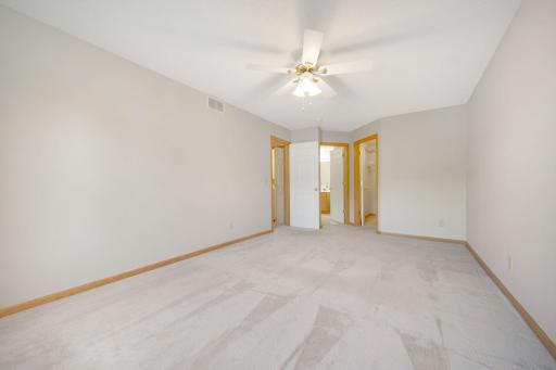 Large primary bedroom with walk in closet and walk through to the full bathroom