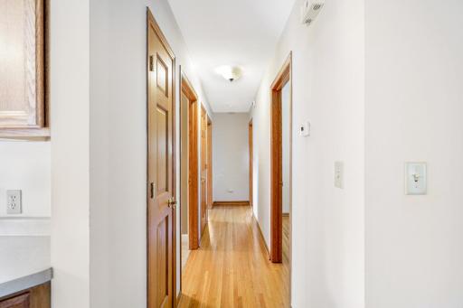 This hallway features 2 closets and provides access to the main-level bedrooms and the full bathroom.