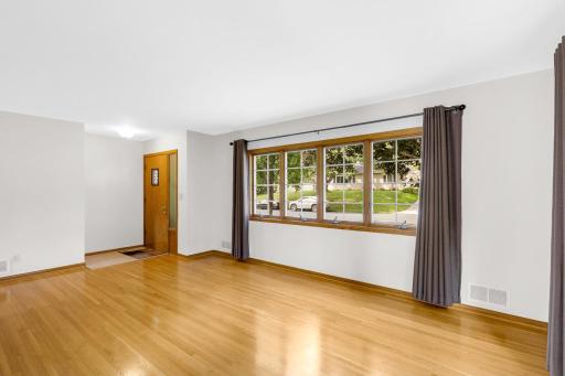 Beautifully finished hardwood floors span the main level which boasts 3 bedrooms, a full bathroom, and a spacious and bright living room.