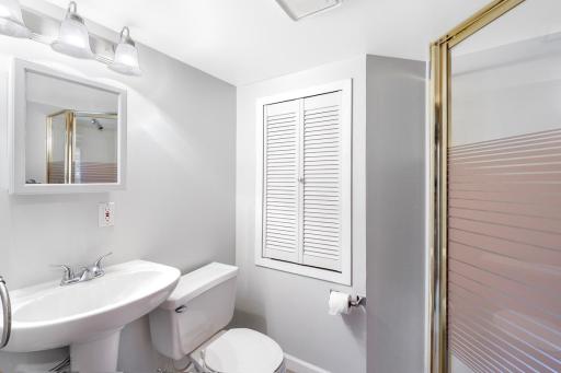 This 3/4 bathroom serves the 4th bedroom and lower-level common spaces.