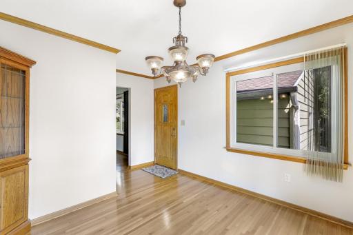 The dining room, bright and open to the living room, provides access to the deck and backyard space.