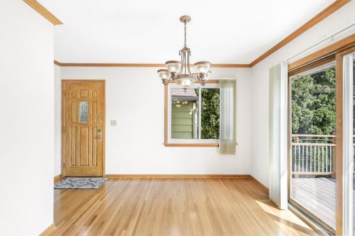 The dining room, bright and open to the living room, provides access to the deck and backyard space.