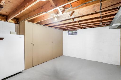 The lower level also offers ample storage space with a dedicated storage room and a large utility/laundry space.