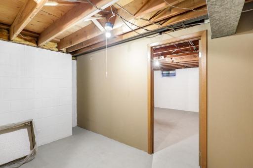 The lower level also offers ample storage space with a dedicated storage room and a large utility/laundry space.