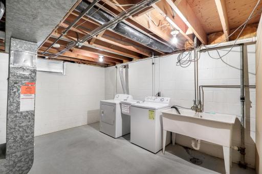 The lower level also offers ample storage space with a dedicated storage room and a large utility/laundry space.