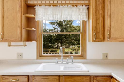 The kitchen is open to the dining room and features east-facing windows which invite morning sun to fill the space.