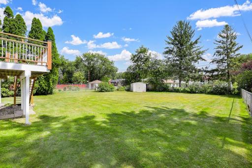 The large, flat, usable backyard has mature trees for partial privacy and provides plenty of open space for yard games and relaxation.