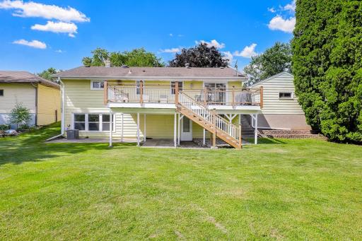 The large, flat, usable backyard has mature trees for partial privacy and provides plenty of open space for yard games and relaxation.