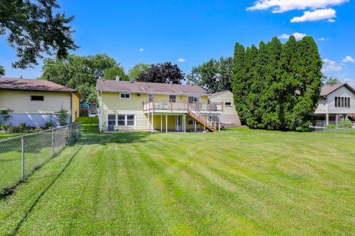 The large, flat, usable backyard has mature trees for partial privacy and provides plenty of open space for yard games and relaxation.