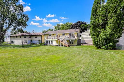 The large, flat, usable backyard has mature trees for partial privacy and provides plenty of open space for yard games and relaxation.