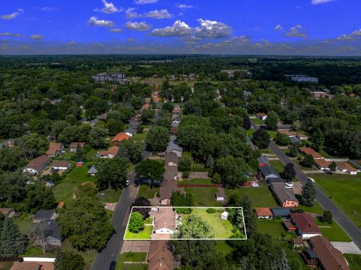 The large, flat, usable backyard has mature trees for partial privacy and provides plenty of open space for yard games and relaxation.