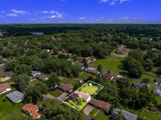 The large, flat, usable backyard has mature trees for partial privacy and provides plenty of open space for yard games and relaxation.