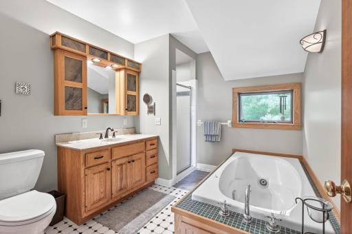 Primary bath has separate jetted tub, shower and natural light .