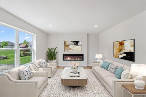 Illustration Purposes Only - Living room with electric fireplace is open to the kitchen and dining room, which makes it perfect for entertaining!