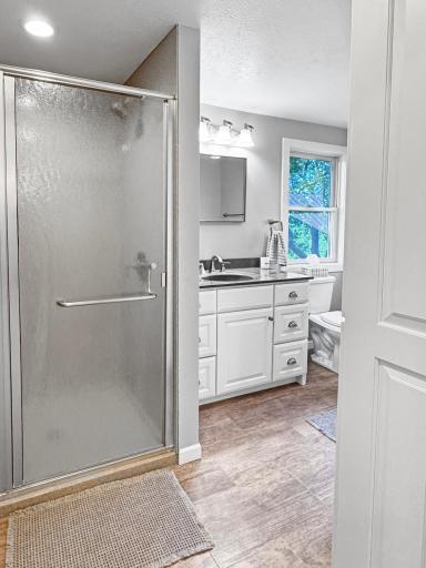 Full bathroom upstairs with onyx shower surround, and tile tub - fully renovated!