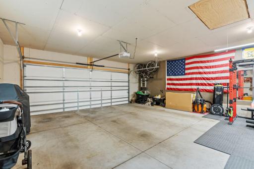 Large 2 car garage with concrete flooring and room for extra storage