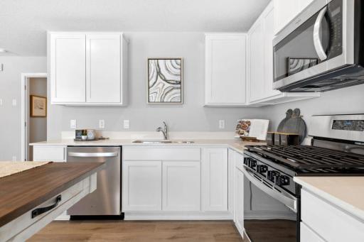 Welcome Home to The Harlow! Similar kitchen layout, home will feature a built in island. Kitchen window will be excluded. Photo of a similar layout model home, layout and colors will vary.