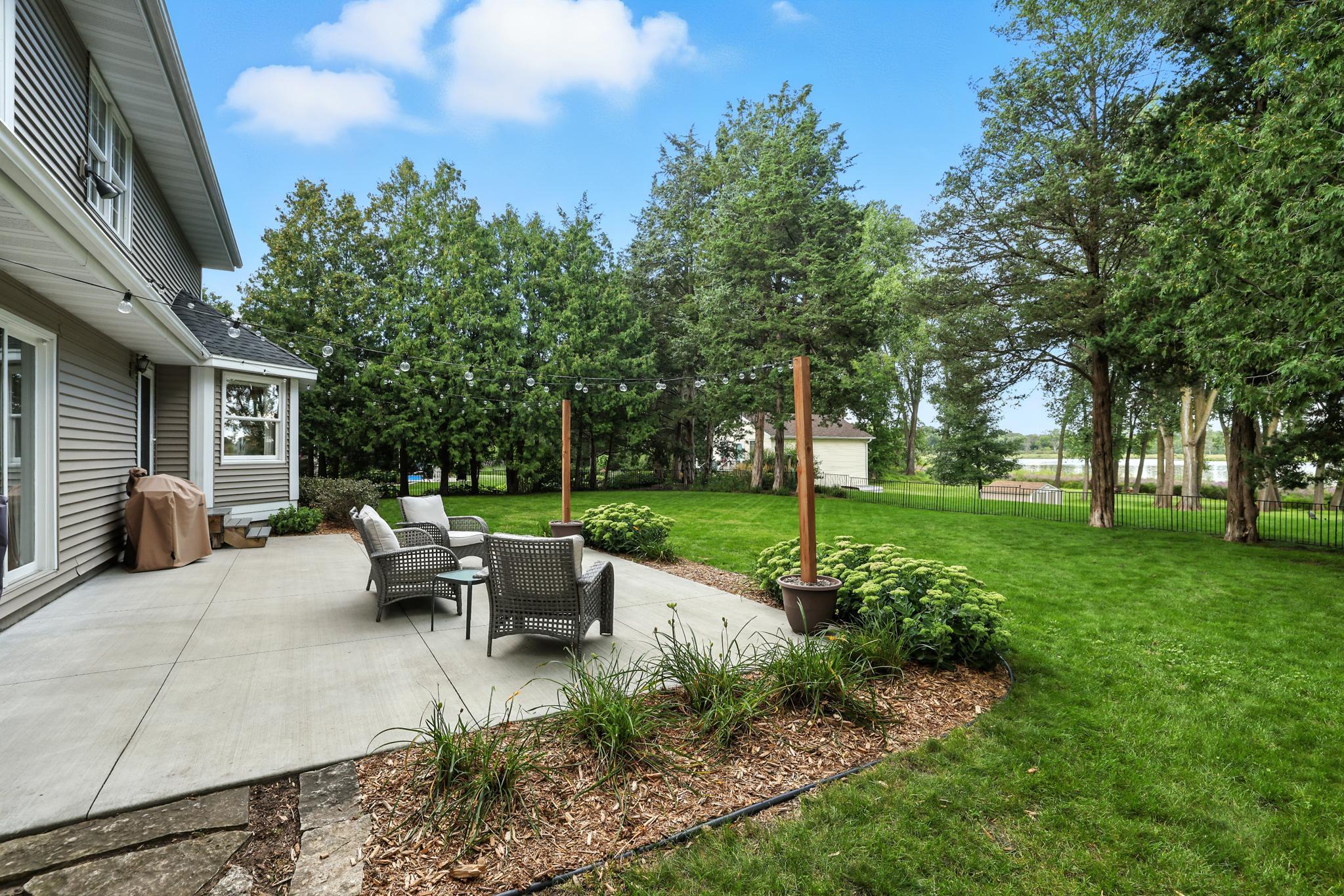 Lovely rear exterior patio space overlooking Rice Lake