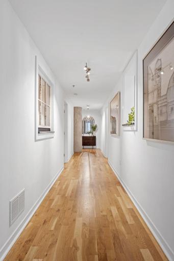 Down the hall are the private interior bedroom/office and the primary suite.