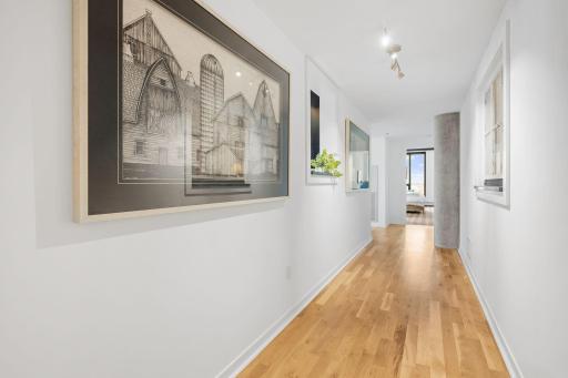 Track lighting to highlight your favorite pieces throughout the hallway.