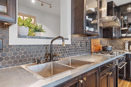 Stainless steel countertops are easy to clean and maintain, and give this space a modern touch.
